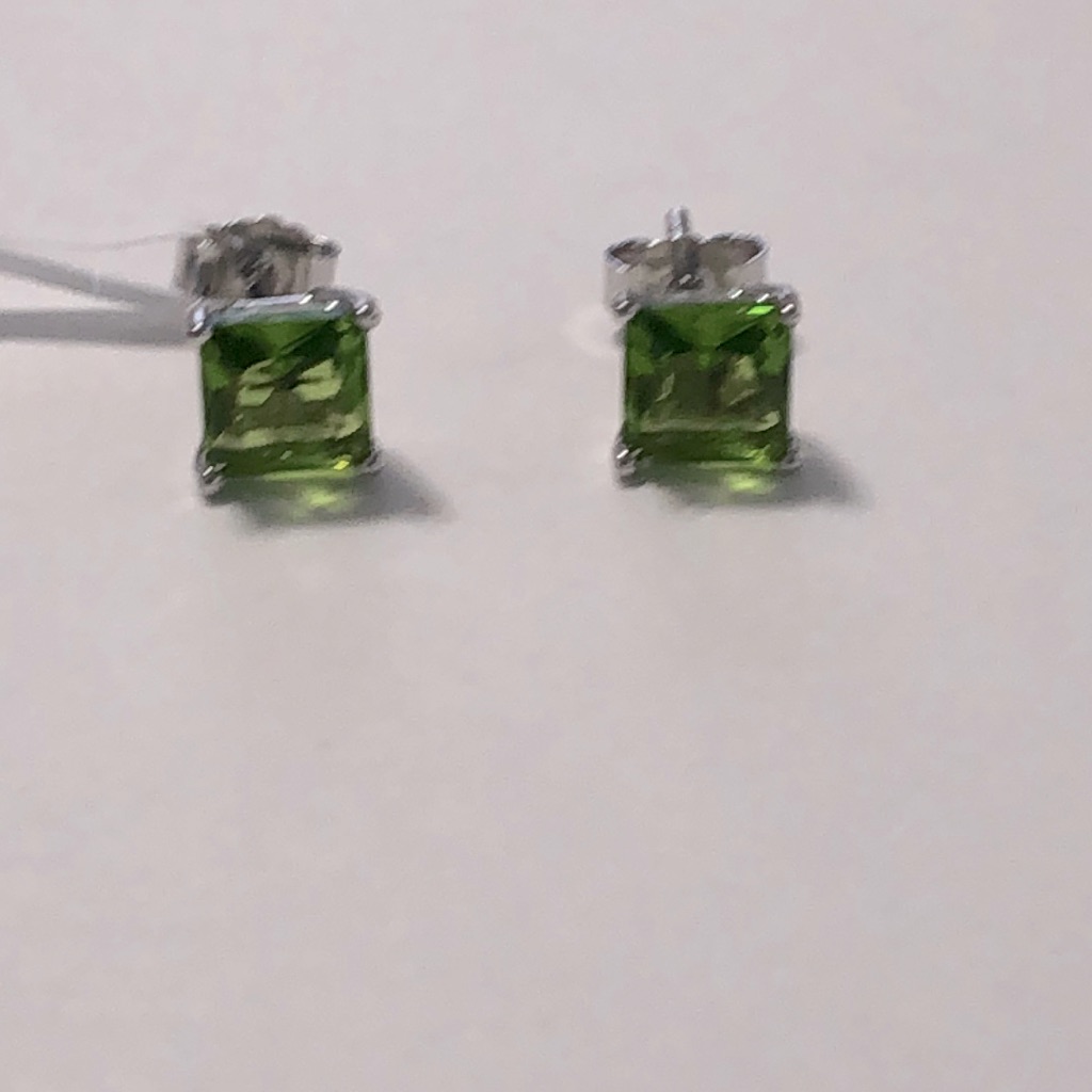 A Beautiful Pair Of Green Birthstone Earrings On Silver
